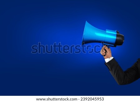 Loudhailer, hands holding megaphone. Announcement, advertising, public hearing concept. Mockup design with loudspeaker, background with blank empty space for copy space Royalty-Free Stock Photo #2392045953