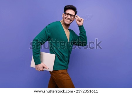 Photo of cheerful attractive man wear trendy clothes going office carrying wireless netbook device isolated on violet color background