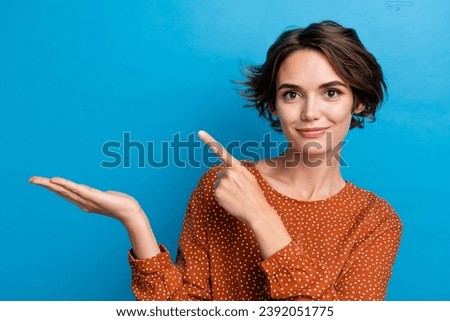 Photo of charming businesswoman holding novelty product at open arm sale isolated over blue color background