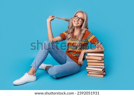 Full length photo of dreamy thoughtful lady wear print shirt reading book stack pile looking empty space isolated blue color background