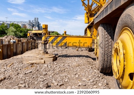 Extended side hydraulic outrigger, stabilizer to increase crane stability until is under heavy duty.  Royalty-Free Stock Photo #2392060995