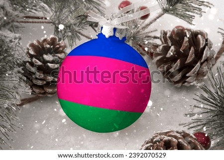 Christmas ball with the flag of Kuban, decorates the snow tree with snowfall. The concept of the Christmas and New Year holiday