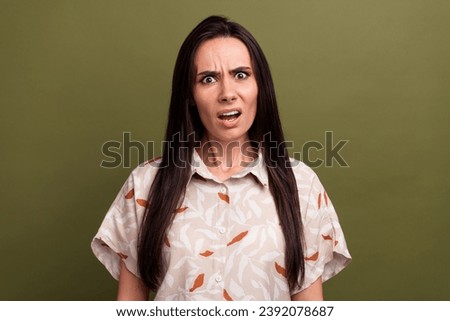 Portrait of offended astonished girl with long hairstyle wear stylish blouse gloomy staring at you isolated on khaki color background Royalty-Free Stock Photo #2392078687