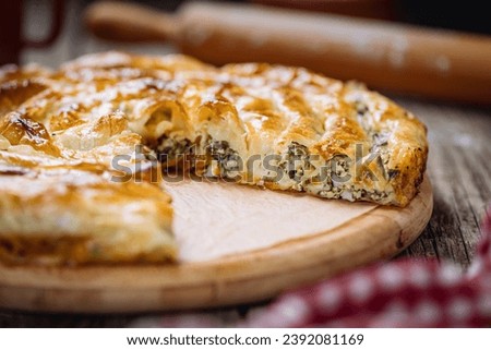 Traditional Bosnian and Turkish meal made from rolled pastry filled with spinach. In Turkey it is called Borek. In Bosnia this dish is called Pita Zeljanica. Made from phyllo  Royalty-Free Stock Photo #2392081169
