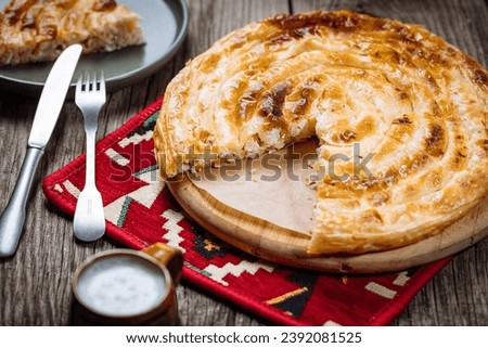 Traditional Bosnian and Turkish meal made from rolled pastry filled with spinach. In Turkey it is called Borek with cheese. In Bosnia this dish is called Pita Sirnica. Made from phyllo pastry. Royalty-Free Stock Photo #2392081525