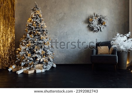 Christmas tree with gifts decorated for new year with lights garland