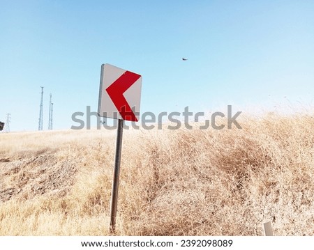 left turn sign among dried grass, traffic sign left turn, roadside warning sign left turn