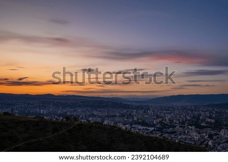 Capturing Mtatsminda Park sunset Tbilisi's Majesty in the Panoramic view Over the Mountains – A Tapestry of Georgia's Capital