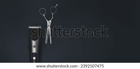Hair clipper and Hairdresser scissors on black background. Hairdresser salon equipment. Premium hairdressing Accessories. Business Card