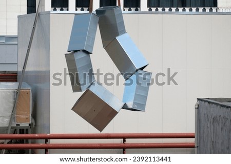 Tubes of the ventilation ducts made of galvanized steel hanged on the rope