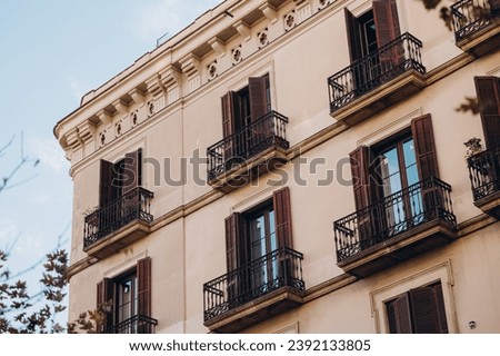 colonial architecture of Europe, balconies of an old house in Europe, old quarter in Barcelona, symbol of Catalonia Royalty-Free Stock Photo #2392133805