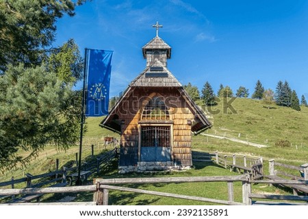 Chapel of the Queen Mary of Peace on the Uskovnica mountain meadow on Pokljuka Royalty-Free Stock Photo #2392135891