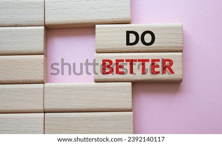 Do better symbol. Wooden blocks with words Do better. Beautiful pink background. Business and Do better concept. Copy space.