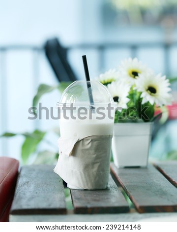 Milk shake  with a flower in coffee shop.
