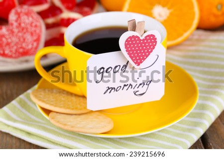 Cup of tea with card that says good morning on table close-up