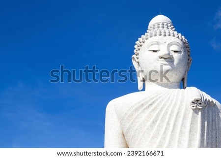 White marble Phuket Big Buddha - The Great Buddha of Phuket statue with bright blue background, Phuket, Thailand 