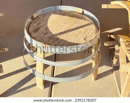 An oak wine barrel table is a fun and simple idea for outdoor furniture that is old fashioned and quirky. Countryside lifestyle. Cute and unusual wooden furniture for the restaurants and testing rooms Royalty-Free Stock Photo #2392178207