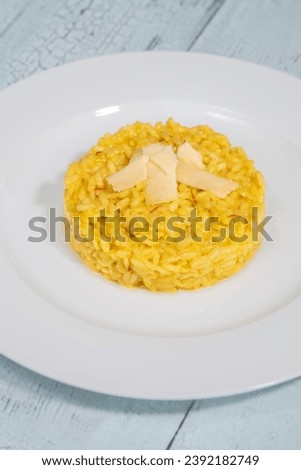 Portion of saffron risotto on the white plate