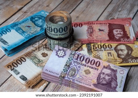 A pile of Hungarian forint (HUF) banknotes on a table. Close-up. Large denominations, inflation and financial situation in Hungary.