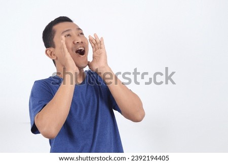 Asian man with open mouths raising hands screaming aside announcement isolated on white background Royalty-Free Stock Photo #2392194405