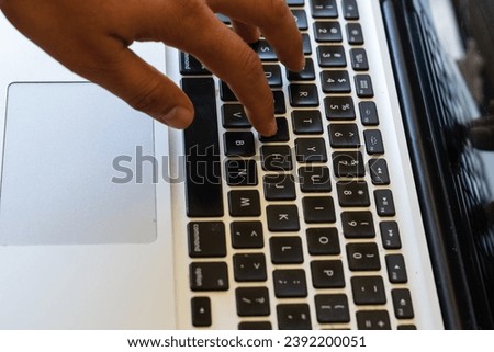 Hands typing on laptop keyboard. Close-up of hands typing and pointing at a computer screen