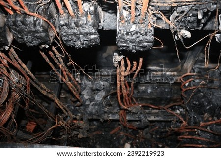 photo of the former electrical panel short circuiting and burning.