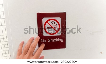 red and white no smoking sign on wall, symbolizing smoke-free zone and health awareness