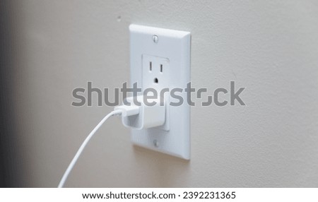 electrical outlet on white wall, concept of power, connectivity, and modern technology in home or office Royalty-Free Stock Photo #2392231365