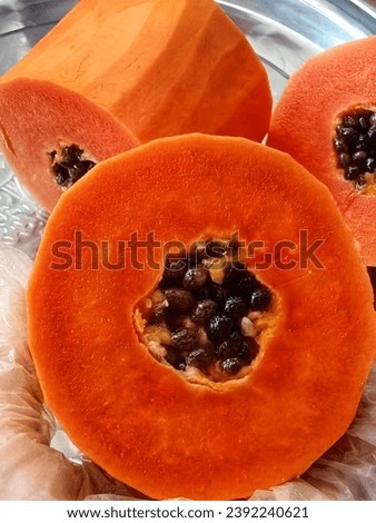 A close up of a papaya cut in half. beautiful picture of red Papaya.