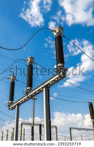 Gas-insulated current transformers at a high-voltage substation. Royalty-Free Stock Photo #2392259719