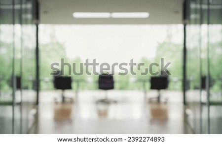 Modern business office without people with blurred bokeh background. tables, chairs, computers, plan . copy space. green office concept