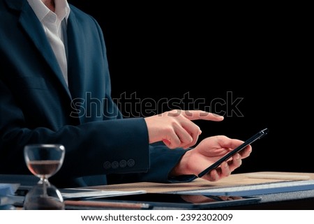 Close-up of a businessman using a smart phone to work in the office
