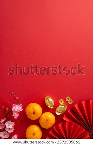 Enchanting Lunar New Year composition. Vertical top view fans, feng shui items, coins, sycee, Hong Bao, tangerines, sakura on a red backdrop, featuring an empty space for text or promotional content