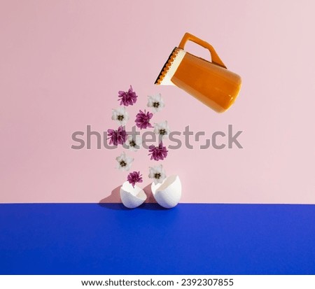 A ceramic jug pouring flowers into the eggshells on the dark blue and purple background. Minimal creative concept. Easter pattern. Floral layout. Copy space.
