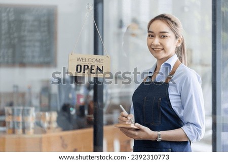 Happy smelling Asian woman owner with open sign broad and ready to service, Small startup business concept.