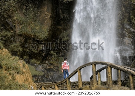 School boy graduation in waterfall 