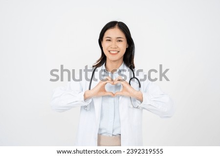 Young beautiful doctor woman wearing stethoscope over white background smiling in love doing heart symbol shape with hands.