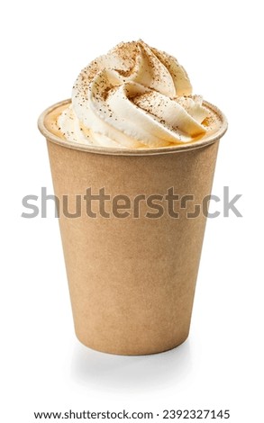 cardboard paper take away cup of pumpkin drink decorated with whipped cream and cinnamon isolated on white background