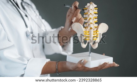 doctor teaching nurses sensitive points of lumbar and pelvis bones.     