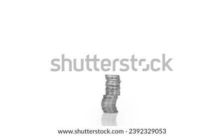 Coins are arranged in high and low shelves, mixed together. There is a reflection on the floor. Shows the value of money in today's economy. The background of the picture is white.