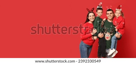 Happy family in Christmas sweaters on red background with space for text
