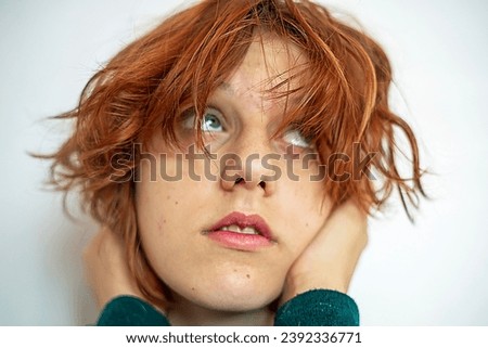 close-up portrait of a beautiful teenage girl with red anime hair on a light background