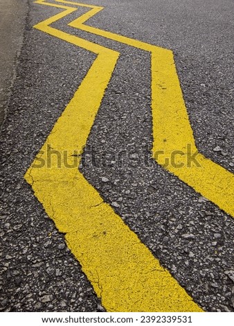 yellow zig zag lines on the asphalt road