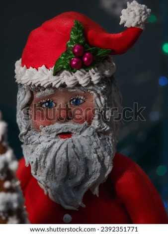 Santa Claus candy doll with Christmas tree and snowflakes in the background
