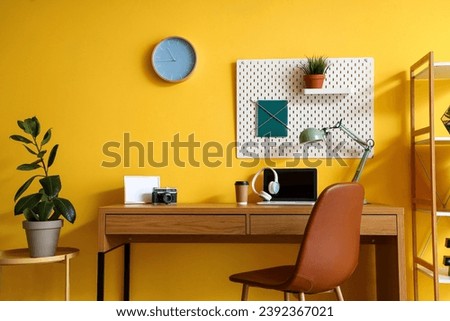 Interior of home office with workplace and pegboard