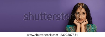 jolly indian woman in traditional clothes posing with hands under chin looking at camera, banner