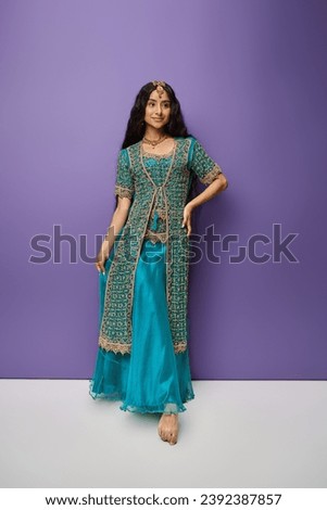 vertical shot of beautiful indian woman in traditional clothes smiling happily and looking away