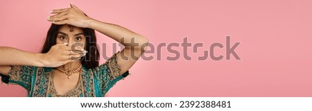 beautiful indian woman in blue sari covering her face with hands while dancing lively, banner