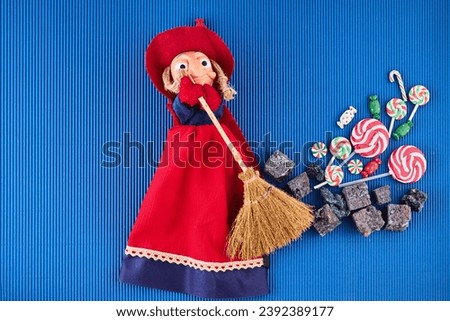 The Befana with sweet coal and candy. Italian Epiphany day tradition. Royalty-Free Stock Photo #2392389177