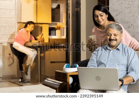 Couple watching together online media content on laptop at home